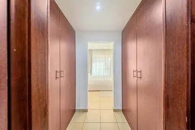 a corridor with wooden doors in a room at Brand new Rimal 2BD in front of The JBR Beach in Dubai