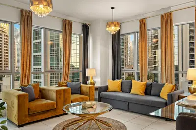 a living room with furniture and large windows at FIRST CLASS 1BR Spectacular Fountain Views in Dubai