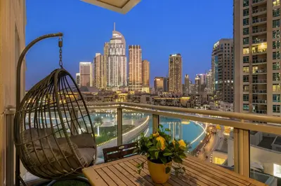 a balcony with a hammock and a view of a city at FIRST CLASS 1BR Spectacular Fountain Views in Dubai