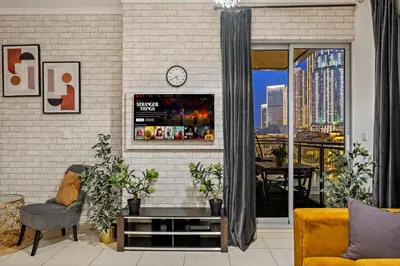 a living room with a clock on a brick wall at FIRST CLASS 1BR Spectacular Fountain Views in Dubai