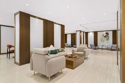 a living room with two chairs and a couch at Radisson Dubai Damac Hills in Dubai