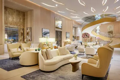 a lobby with couches and tables and a salon at The St. Regis Dubai, The Palm in Dubai