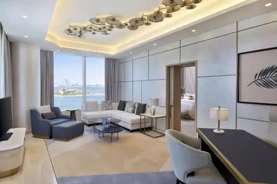 a living room with a couch and a table and chairs at The St. Regis Dubai, The Palm in Dubai