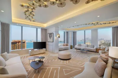 a living room with white furniture and large windows at The St. Regis Dubai, The Palm in Dubai