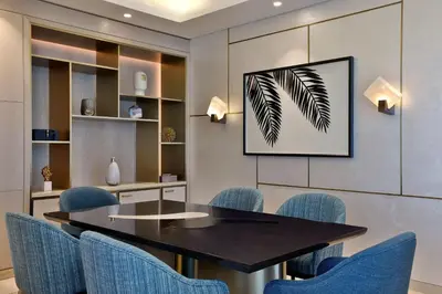 a dining room with a table and blue chairs at The St. Regis Dubai, The Palm in Dubai