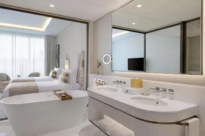 a bathroom with two sinks and a large mirror at The St. Regis Dubai, The Palm in Dubai