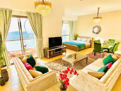 a living room with two couches and a television at Luxury Casa - Royal Sea View Apartment JBR Beach 2BR in Dubai