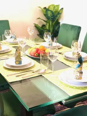 a table with plates of food and glasses on it at Luxury Casa - Royal Sea View Apartment JBR Beach 2BR in Dubai