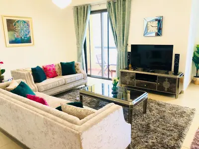 a living room with two couches and a television at Luxury Casa - Royal Sea View Apartment JBR Beach 2BR in Dubai