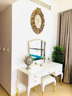 a white desk with a mirror and a clock on the wall at Luxury Casa - Royal Sea View Apartment JBR Beach 2BR in Dubai
