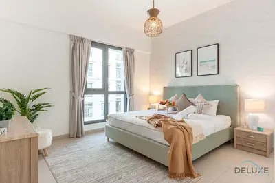 a bedroom with a bed and a large window at Blissful 1BR in Safi Town Square by Deluxe Holiday Homes in Dubai