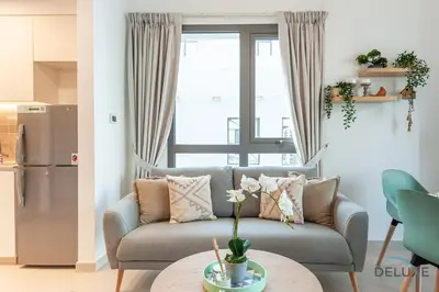 a living room with a couch and a table at Blissful 1BR in Safi Town Square by Deluxe Holiday Homes in Dubai