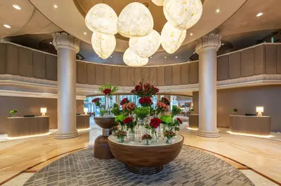 a lobby with a table with flowers in it at Sheraton Jumeirah Beach Resort in Dubai