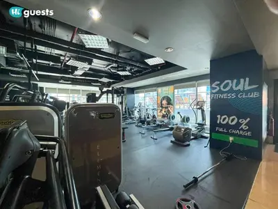 a gym with several treadmills and machines in it at HiGuests - Fabulous Duplex With Breathtaking Lake Views in Dubai
