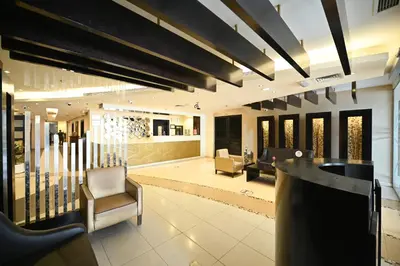 a lobby with a bar and chairs in a building at Al Waleed Holiday Homes in Dubai