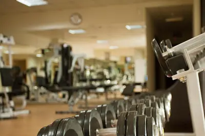 a row of dumbbells in a gym at Al Waleed Holiday Homes in Dubai