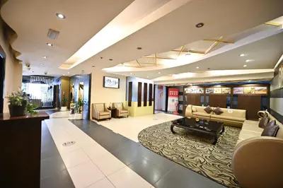 a lobby with a couch and chairs and a table at Al Waleed Holiday Homes in Dubai