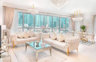 a living room with white furniture and a large window at Elite Royal Apartment - Full Burj Khalifa & Fountain View - Sapphire in Dubai