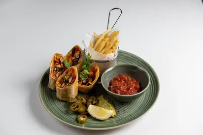a plate of food with a sandwich and french fries at ABAR HOTEL APARTMENTS DIP-1 in Dubai