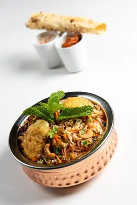 a bowl of food on a plate on a table at ABAR HOTEL APARTMENTS DIP-1 in Dubai