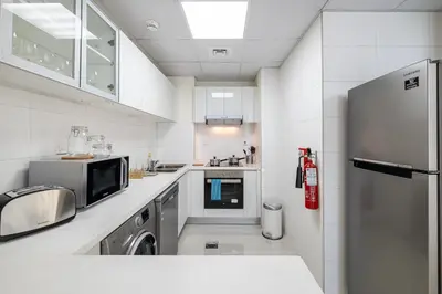 a kitchen with a refrigerator and a dishwasher at Charming 3 BR with walking distance to the Beach in Dubai