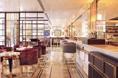 a restaurant with a bar with tables and chairs at Tamani Marina Hotel & Apartments in Dubai