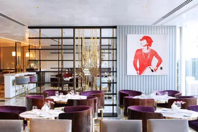 a dining room with tables and purple chairs at Tamani Marina Hotel & Apartments in Dubai