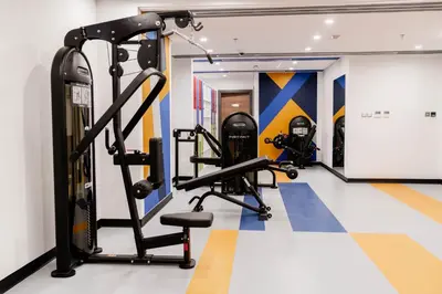 a gym with two tread machines in a room at Resivation Hotel in Dubai