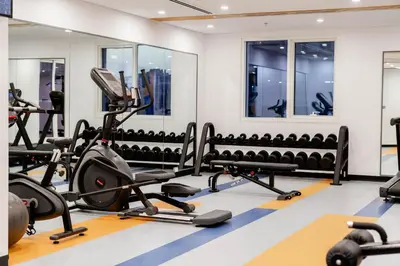 a gym with treadmills and exercise equipment at Resivation Hotel in Dubai