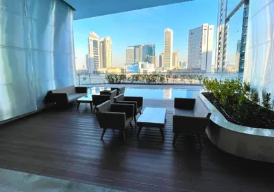 a balcony with tables and chairs and a view of a city at RH- Modern Comfort & bright 1BR near Dubai Mall, City Views in Dubai