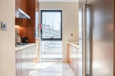a kitchen with a door leading to a window at RH- Downtown Oasis, Spacious 01 BR in Downtown near Dubai Mall in Dubai