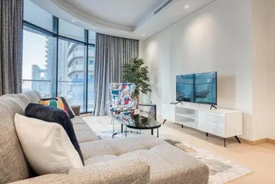a living room with a couch and a tv at RH- Downtown Oasis, Spacious 01 BR in Downtown near Dubai Mall in Dubai