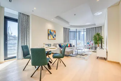 a living room with a table and chairs at RH- Downtown Oasis, Spacious 01 BR in Downtown near Dubai Mall in Dubai