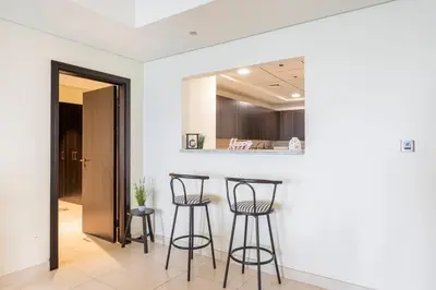 a kitchen with three bar stools in a room at Balqis Residense Palm Jumeirah,Pool, Beach, Top floor, Full sea view, Restaurants in Dubai