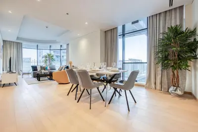 a dining room with a table and chairs at RH- Upscale Living in the Heart of the City, 02BR, Near Dubai Mall in Dubai