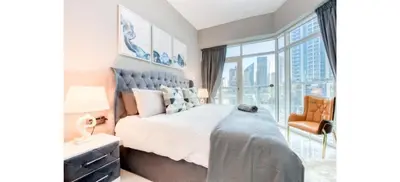 a bedroom with a bed and a large window at Luxurious 4-Bedroom Duplex VILLA Apartment near JBR in Dubai