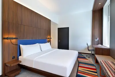 a bedroom with a large white bed in a room at Aloft Al Mina, Dubai Jumeirah in Dubai