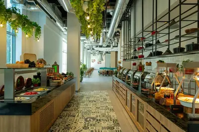 a bakery with a long aisle with food at Aloft Al Mina, Dubai Jumeirah in Dubai