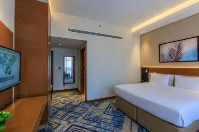 a hotel room with a bed and a flat screen tv at S19 Hotel-Al Jaddaf Metro Station in Dubai