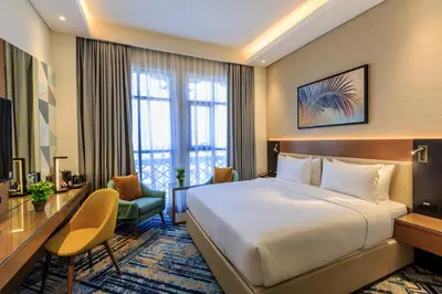 a hotel room with a bed and a desk at S19 Hotel-Al Jaddaf Metro Station in Dubai
