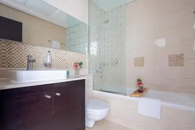 a bathroom with a sink and a toilet and a tub at Frank Porter - Mon Reve in Dubai