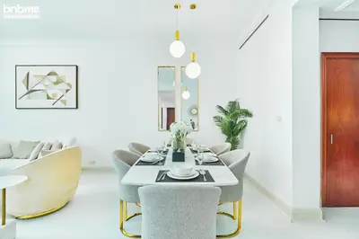 a dining room with a table and chairs at bnbme - Dubai Marina 2BR Apt w Private Jacuzzi Pool Gym Near JBR Beach & Marina Walk in Dubai