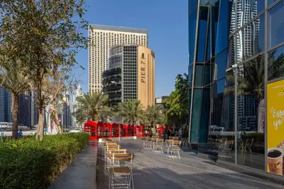 a city street with tables and chairs and buildings at Frank Porter - Silverene in Dubai