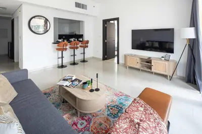 a living room with a couch and a table at Frank Porter - Silverene in Dubai