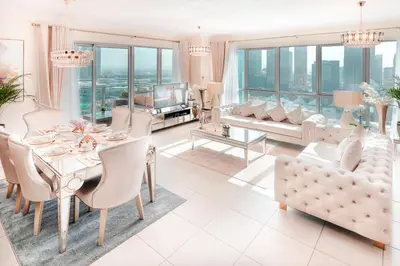 a living room with a table and chairs and a couch at Elite Royal Apartment - Full Burj Khalifa & Fountain View - Emerald in Dubai