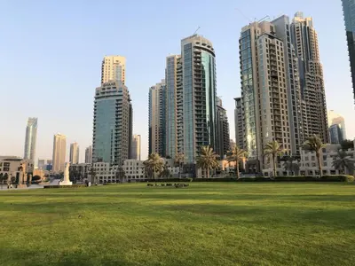 a park in front of a city with tall buildings at Elite Royal Apartment - Full Burj Khalifa & Fountain View - Ruby in Dubai