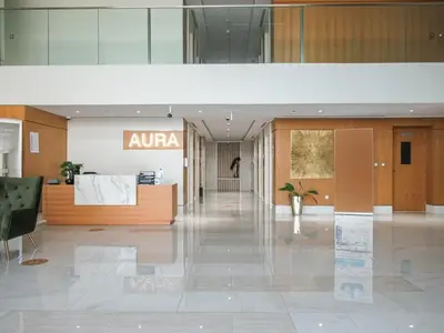 an empty lobby with aania sign in a building at Frank Porter - Azizi Aura in Dubai