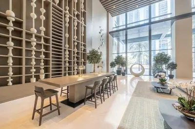 a dining room with a long table and chairs at Boho-Chic Cosy 1BR, minutes to Burj Khalifa in Dubai
