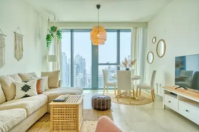 a living room with a couch and a table at Boho-Chic Cosy 1BR, minutes to Burj Khalifa in Dubai