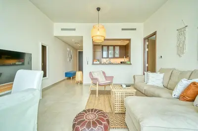 a living room with a couch and a table at Boho-Chic Cosy 1BR, minutes to Burj Khalifa in Dubai